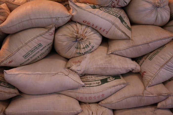 Stacks of fertilizer bags with printed labels, illustrating the importance of understanding fertilizer labels and N-P-K ratios to provide the right nutrients for plant growth and health.