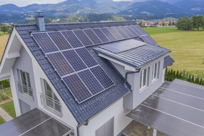 Solar panels installed on the roof of a modern house, illustrating the step-by-step process of solar panel installation and tips for finding the right contractor.