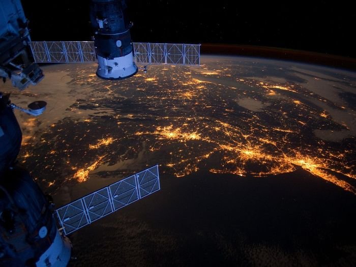 Satellite capturing night-time view of Earth, representing the use of satellite data for crop forecasting and area assessment in agriculture.