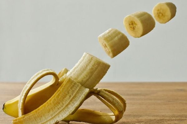 Freshly peeled banana with sliced sections, showcasing the potassium-rich benefits of homegrown bananas from your own garden.