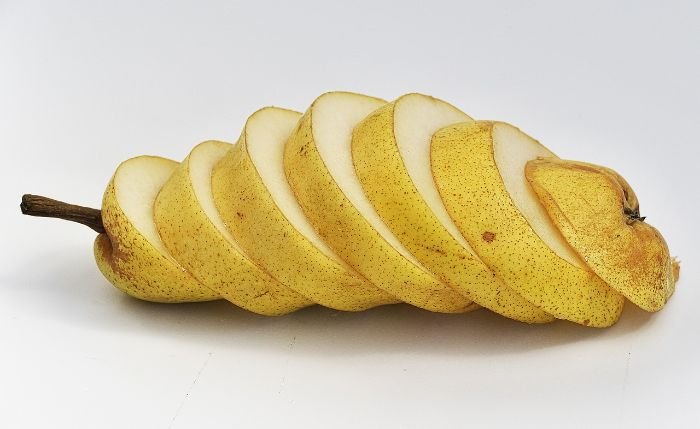 Sliced pear showing its fiber-rich texture, used to compare different fiber sources in fruits and vegetables for digestive health.
