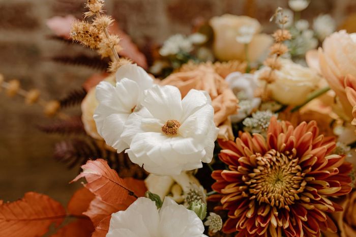 A close-up of a mixed floral arrangement featuring chrysanthemums and white flowers, symbolizing the importance of staying informed about emerging pests and diseases to protect and maintain healthy plants.