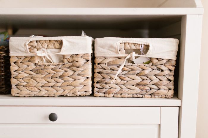Woven baskets on a white shelf used for hidden storage, providing a tidy and organized look in minimalist home decor.