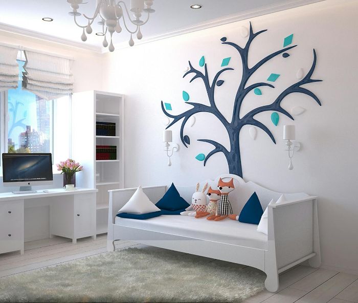 Minimalist children's room with wall art, plush toys, and clean white furniture adding personal touches and character