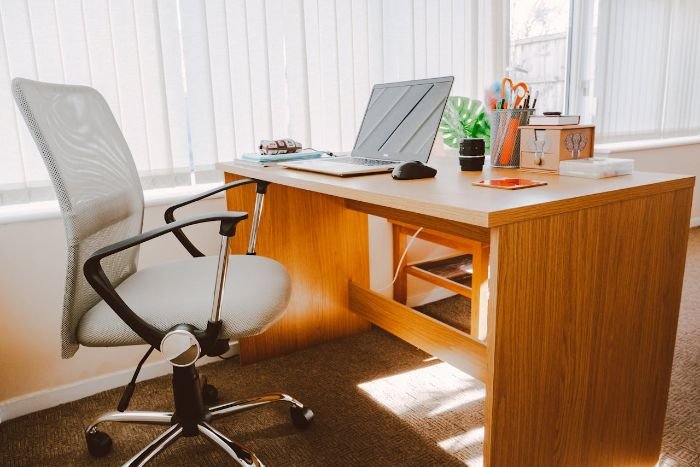 A modern home office setup featuring a durable wooden desk and ergonomic chair, promoting sustainability and long-lasting furniture choices.