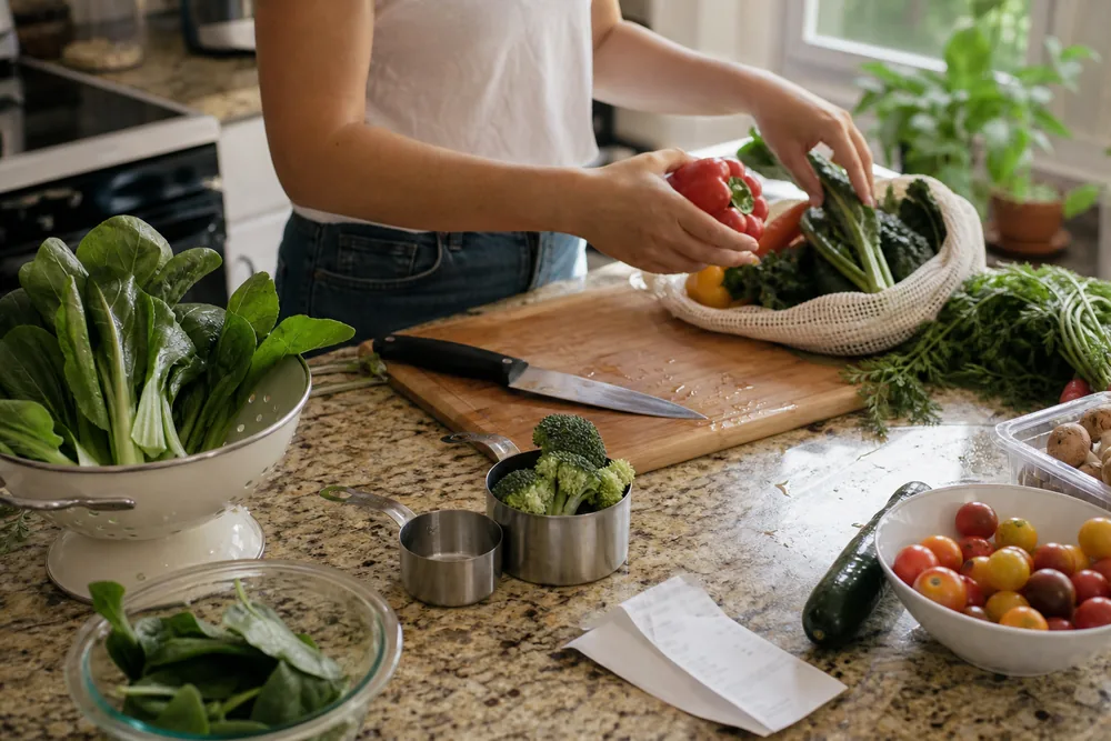 Home kitchen counter with vegetables and measuring cups showing vegetable consumption statistics in daily meal prep